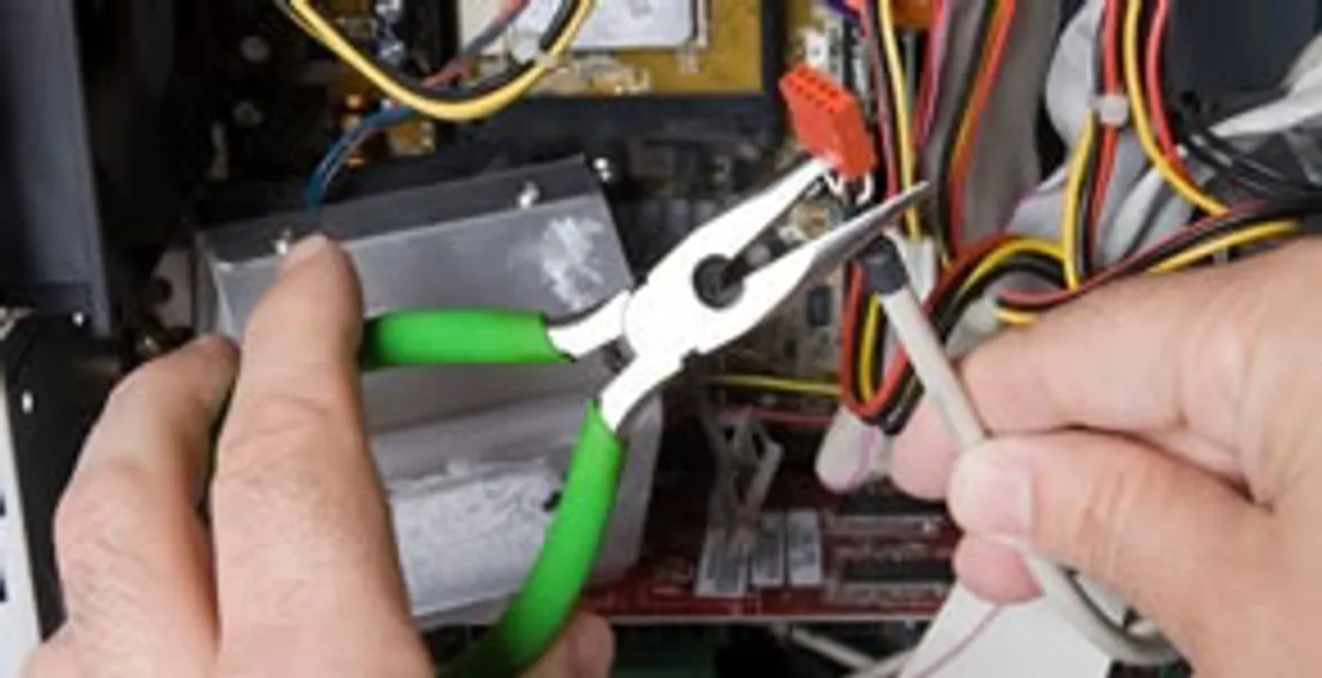 Licensed electrical contractor performing electrical repair with tools in Camby, IN